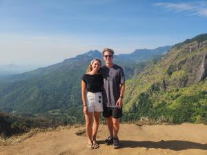 a man and woman standing on top of a mountain at Milan Home Stay in Ella