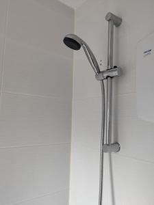 a shower with a shower head in a bathroom at Modern living in Hull in Hull +14 photos