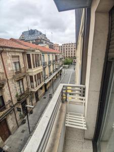 a bench on a window sill looking out at a street at Hostal Sol in Zamora