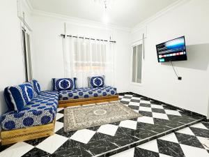 a living room with a couch and a checkered floor at Ftouh House Heart of Tangier in Tangier