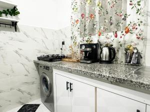a kitchen with a counter and a washing machine at Ftouh House Heart of Tangier in Tangier