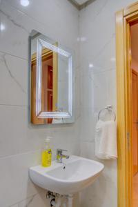 a white bathroom with a sink and a mirror at Timitar, your own Cozy apartment in Agadir +19 photos