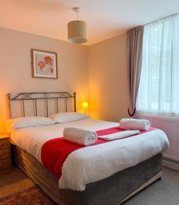 a bedroom with a bed with towels on it at The Western in St Ives