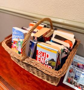 a basket filled with books on a table at The Western in St Ives