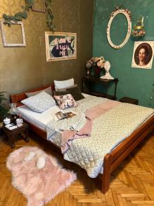 a bedroom with a bed with a pink rug at Creative Apartment Kaleidoscope in Belgrade