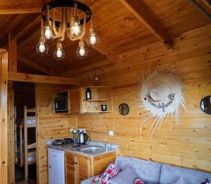 a kitchen with a sink in a wooden cabin at Countryside's Tiny House in Ben Slimane