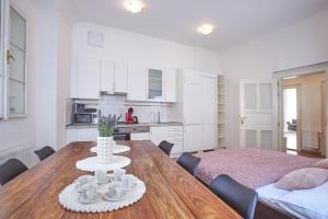 a kitchen and dining room with a table and chairs at Charles Bridge Apartments in Prague