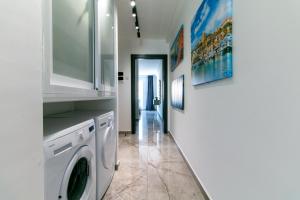 a laundry room with a washer and dryer at Spinola Seafront Deluxe in St. Julianʼs