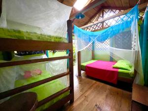 a bedroom with two bunk beds in a house at Palmeras del Río HOTEL in La Viña