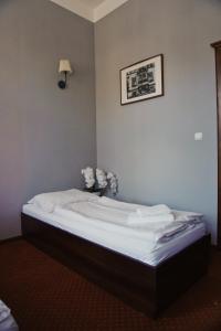 Łóżko lub łóżka w pokoju w obiekcie Legnicki Browar Książęcy Hotel i Restauracja