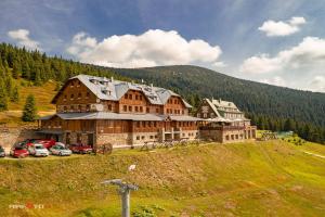 a large building on the side of a hill at Horsky hotel Stumpovka in Rokytnice nad Jizerou
