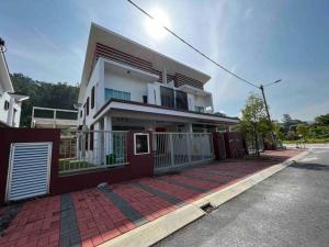 a white house with a red fence on a street at GioiaHome with 6 bedroom and 15 guest in Taiping