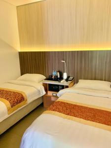 Postel nebo postele na pokoji v ubytování Kojõ Hotel Tagum