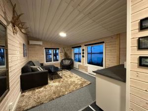a living room with a couch and a table at Camp Caroli Mini lodge in Kiruna