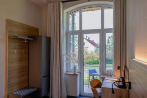 a room with a large window with a view of a crane at Gästehaus am Lausitzring in Poley