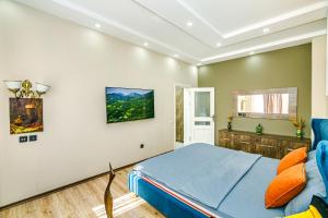 a bedroom with a blue bed and a couch at Little Gem in the Old City - One Bedroom in Baku