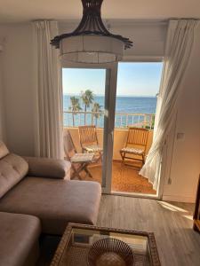 a living room with a couch and a view of the ocean at Casa Bartolo in Murcia