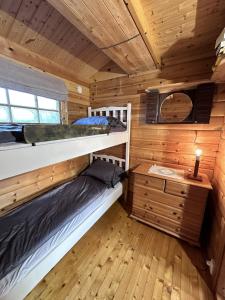 a bedroom with bunk beds in a wooden cabin at Lofoten Horizon, Fredvang in Fredvang +14 photos