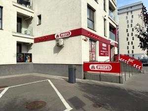 a store with red signs on the side of a building at Studio Plaza Faza 2 in Militari