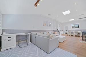 a living room with a couch and a table at Lakefront House - INEA Retreat in Karraganbah