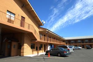 a building with cars parked in a parking lot at Knights Inn South Amboy in South Amboy