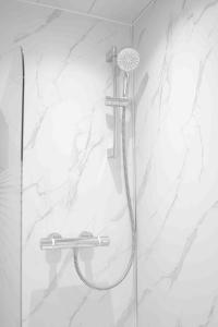 a shower with a shower head in a bathroom at Granby House in Livingston