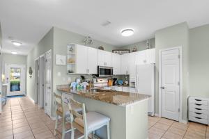 a kitchen with white cabinets and a counter top at Romar Lakes 104B in Orange Beach