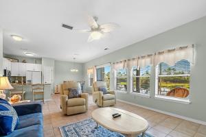 a living room with a couch and chairs and a table at Romar Lakes 104B in Orange Beach