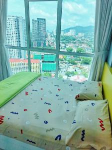 a bed in a room with a large window at 1BR Condo Straits Garden Suites Georgetown Penang in George Town