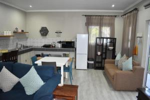 a kitchen and living room with a couch and a table at Lavender Grove in George