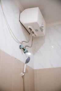 a shower in a bathroom with a shower head at Lily Villa in Seminyak