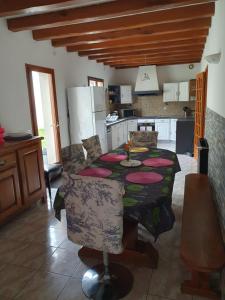 a kitchen with a dining table and a kitchen with a refrigerator at Grande maison 6 chambres indépendante avec jardin et terrasse in Lisses
