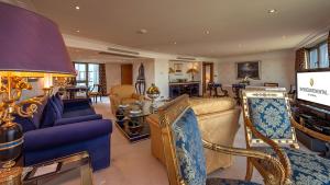 a living room with a couch and a tv at InterContinental Istanbul by IHG in Istanbul