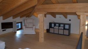 a living room with wooden ceilings and a tv at B&B Piccolo Relais in Lessolo