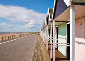 a row of buildings on the side of a beach at Bridlington Holiday Cottages in Fraisthorpe