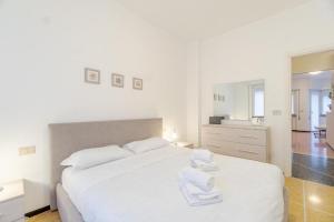 a bedroom with a white bed with towels on it at Venus 3 by PortofinoVacanze in Rapallo
