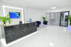 an office lobby with a tv on the wall at Hotel Oaza in Kikinda