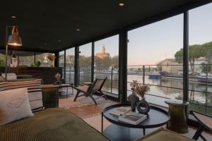 a living room with a view of the water at LA PENICHE - Bed And Bicycle - Aigues Mortes in Aigues-Mortes