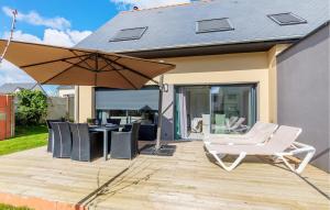 a patio with a white chair and an umbrella at Amazing Home In Saint-Méloir-Des-Ondes in Saint-Méloir-des-Ondes +15 photos
