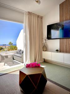 a living room with a large window and a couch at Infinity Ocean View Suite in Adeje