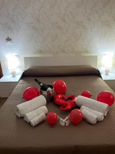 a bed with red balloons and red balloons on it at B&B Bea in Regina