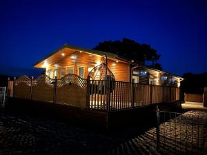 a house with lights on it at night at The Lodge in Congleton