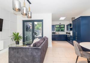 a living room with a couch and a table at Malahide Castle Hideaway in Malahide