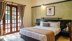 Postel nebo postele na pokoji v ubytování Olive Hotel Alidia Beach Resort by Embassy Group + 37 fotografií