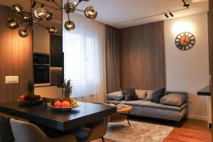 a living room with a couch and a table at ModernApartmentsBL in Banja Luka