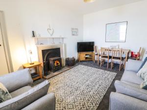 a living room with a couch and a fireplace at North Segganwell - Culzean Castle in Maybole
