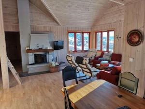 a living room with a couch and a fireplace at Høyfjellshytte in Flå