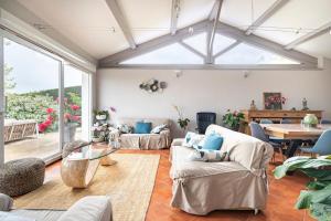 a living room with couches and a table at La Villa Moursoise 4 Etoiles in Mours-Saint-EusÃ¨be
