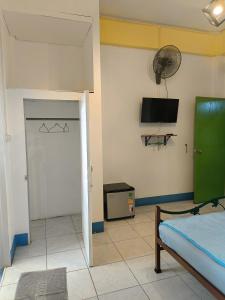 a room with a bedroom with a bed and a flat screen tv at อิ่มละมัยอพาร์ทเม้นท์ in Ban Mai