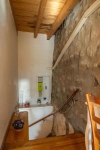 a small kitchen with a stone wall and a stove at Gîte La Peyrade d'Aubrac 6/8 personnes in Marchastel